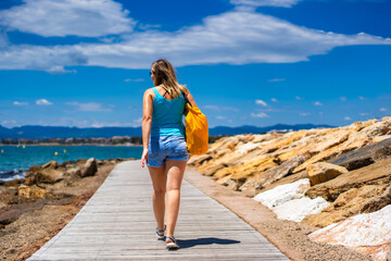 Beautiful woman walking on seaside boulevard - Costa Dorada Spain 