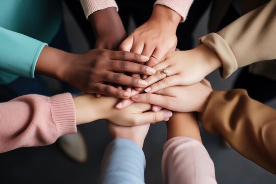 a diverse team stacking their hands in a circle