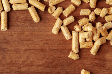 Heap of wooden pellets biofuel on wooden table