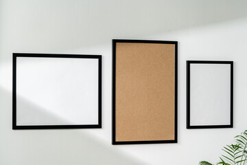 Blank picture frames on the white wall copy space