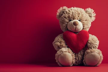 Fotobehang a cute Valentine teddy bear holding a romantic red love heart against a red background © ink drop