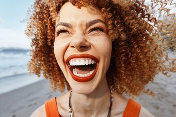 Smiling Woman on Beach with Backpack, Experiencing the Freedom of Hippie Travel