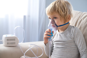 little boy using steam inhaler nebulizer. health medical care.