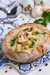 Potato soup with mushrooms in a loaf of bread.