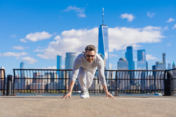 Runner on start. Athlete man ready in running start pose in New York city. Ready for competition....