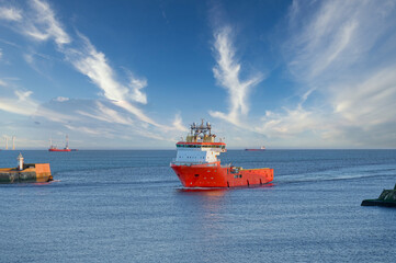 Ship arriving at Aberdeen harbour after passing Girdle Ness Lighthouse
