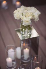 View of elegant expansive white flowers and andles decoration for wedding party. the wedding ceremony in the open air of fresh flowers, with candles. Luxury and beautiful wedding decor. Decor details.