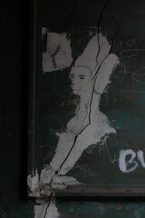 cracks in the form of a pattern on a dark green wall in a low key close-up, 