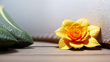 Yellow flower on a wooden table.