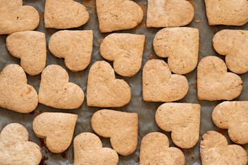 Valentine's Day heart shaped cookies. View from above. Heart-shaped gingerbread cookies on baking sheet. Toned.