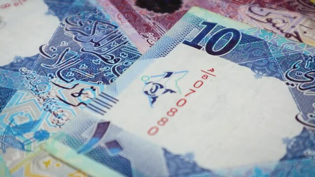 A slow-motion closeup footage of Qatar's banknotes while rotating on a display stand. 