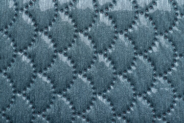 Abstract background quilted with a pattern resembling fish scales © Damian Pawlos