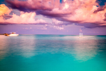 amazing landscape with turquoise sea and pink sunset cloud