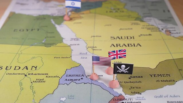 Flags of the USA and Iran surrounding a pirate insignia onto a map of the Red Sea region. copyright-free map. It symbolically represents the intricate geopolitical dynamics and potential conflicts in