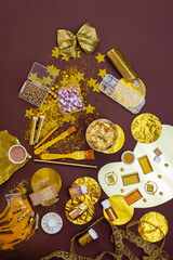 Preparation for the holiday party in golden tones. Decor means and tools of gold color. Gold party decoration.