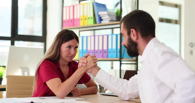 Office workers test strength with arm-wrestling challenge