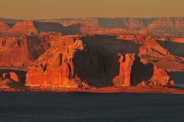 Sunset view of the buttes and cliffs around Lake Powell, over the state border in Utah, from the...