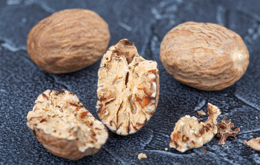 large dry nutmeg closeup on dark background