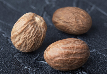 large dry nutmeg closeup on dark background