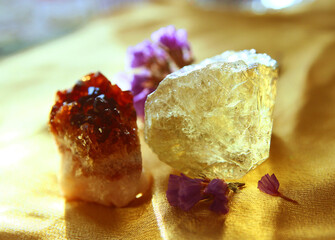 Two pieces of quartz on a golden cloth.
