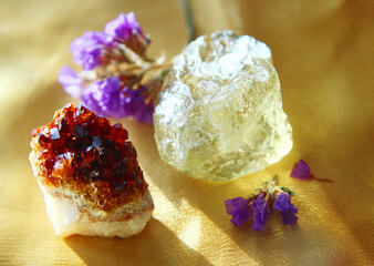 Two pieces of quartz on a golden cloth.