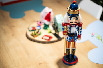 Beautiful and cute modern wooden soldier as  a Christmas decoration on a wooden table