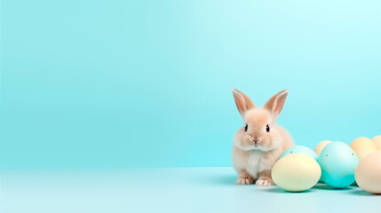 Obraz premium Cute toy little bunny and easter eggs on pastel blue background with place for text. Happy easter card.