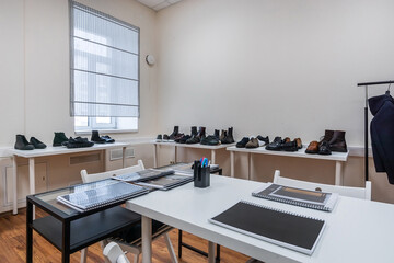 The modern interior of the showroom with a table for visitors and goods presented on the .shelves.