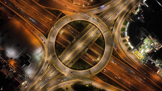 Aerial drone slow shutter night photo of illuminated urban elevated toll ring road junction and interchange overpass passing through Kifisias Avenue, Attica, Greece