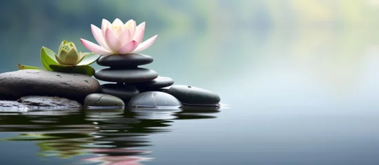 Foto op Canvas Beautiful lotus or lily flower and stack of stones on water surface blur background. Generate AI © Leafart
