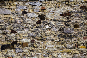 Old shapeless stones create the texture of stone cladding