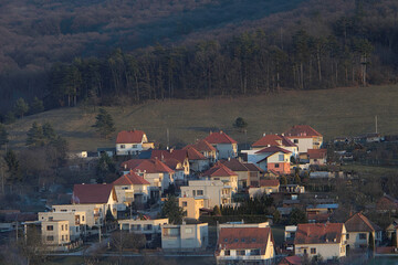 Fototapeta premium village with forest and meadow photographed at sunset