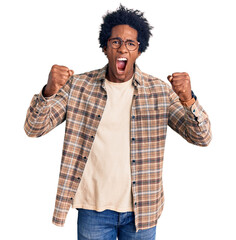 Handsome african american man with afro hair wearing casual clothes and glasses angry and mad...