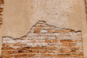 damaged red bricks from the wall of an ancient building