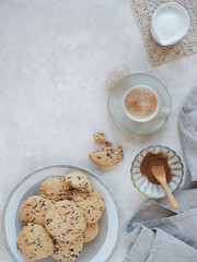 table set with homemade cookies and hot cinnamon milk drink. Top view with copy space.