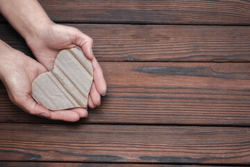 A Heart in hands on valentine's day on a wooden background holiday