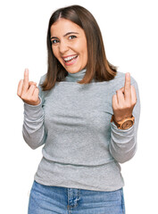 Young beautiful woman wearing casual turtleneck sweater showing middle finger doing fuck you bad...