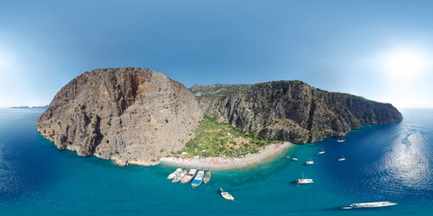 Panoramic view of the Butterfly Valley (Kelebekler Vadisi). Turquoise bay with a beach surrounded...