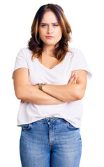 Obraz premium Young beautiful caucasian woman wearing casual white tshirt skeptic and nervous, disapproving expression on face with crossed arms. negative person.