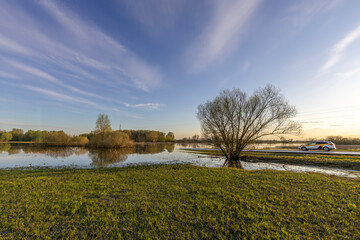 A taxi car cannot pass due to flooding, the road is flooded with water, river flooding, spring flood