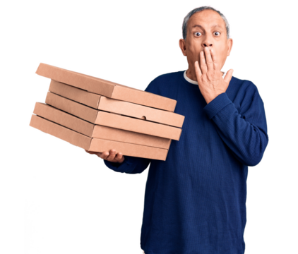 Senior handsome man holding pizza boxes covering mouth with hand, shocked and afraid for mistake. surprised expression