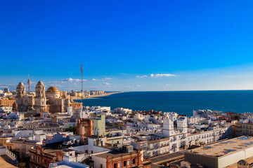 Aerial panoramic view of the old city rooftops and Cathedral de Santa Cruz from tower Tavira in Cadiz, Andalusia, Spain © olyasolodenko