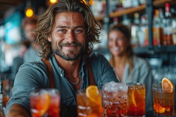 A handsome male bartender serves various cocktails at the bar. The concept of rest and weekends