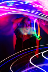 Stylish fashionable dancing blonde in the club neon light. Adult charming woman in modern music futuristic night club.