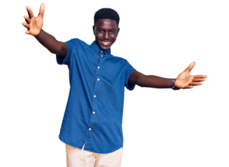 Young african american man wearing casual clothes looking at the camera smiling with open arms for hug. cheerful expression embracing happiness.