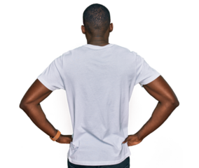 Young african american man wearing casual white t shirt standing backwards looking away with arms on body