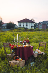 Fall mood, romantic date outdoors in the garden, candlelight dinner for a couple. Private wedding...