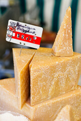 Aged parmesan reggiano cheese in a market - 709331404
