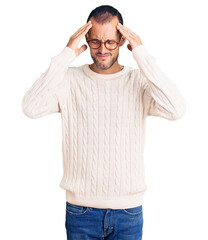 Young handsome man wearing casual clothes and glasses with hand on head for pain in head because stress. suffering migraine.