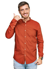 Handsome caucasian man wearing casual clothes smiling doing phone gesture with hand and fingers like talking on the telephone. communicating concepts.